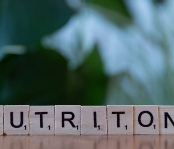 A wooden block spelling nutrition on a table